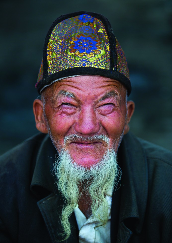 Mahmud, a carpenter in Keriya, retires to a corner of the room, opens a Koran, places it on a wooden trestle under the soft light of a high window, and begins to read.