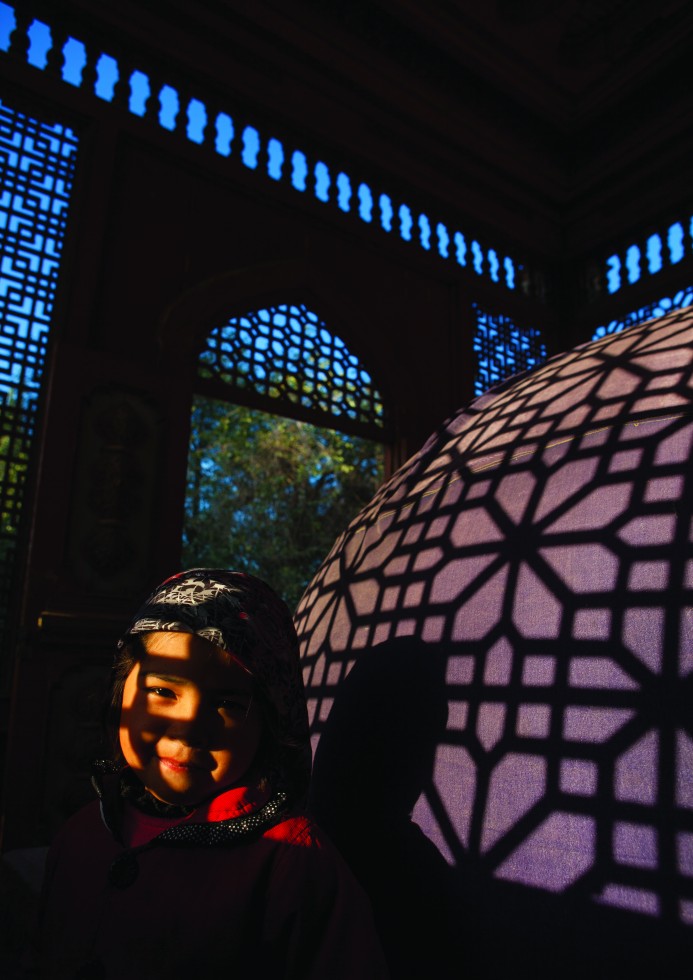 Yarkand: The tombs of Sultan Sayidan in small carved wooden houses let the last rays of the sun seep through.