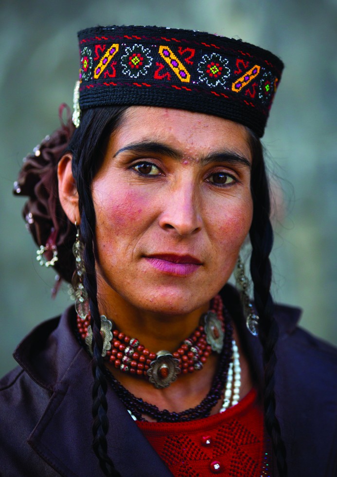 Tajik women wearing colourful and embroidered jewellery, long braids, layered necklaces, earrings and ornaments carved in silver. I wonder where the wedding is. No wedding – they dress like this every day.