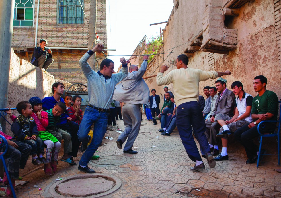 Kashgar: A sign reads “Forbidden to tourists”. I break the law and find myself lost in a labyrinth of back streets in the middle of a Uighur marriage celebration. The men take turns dancing while the women are busy preparing the party at the house of the betrothed.