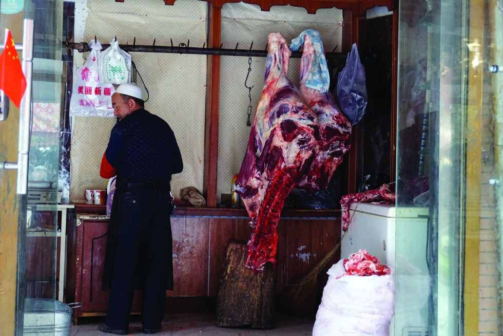 A butcher disassembles livestock in the old town, providing Uyghur families and restaurants with the beef and mutton that go into such staple dishes as plov, or rice pilaf.