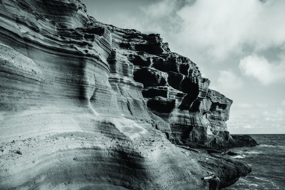 Kona, Hawaii: Minutely tapered hills of staggered honeycomb— wet thunderhead cliff.