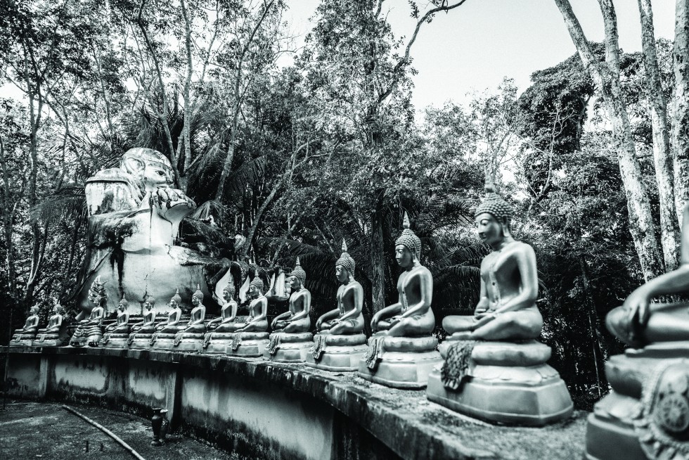 Wat Ko Phayam is worthy of quiet exploration, with jungle and seaside statues, temples and monastic housing.