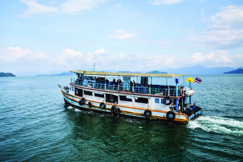 Leaving the island by ferry; arriving from Ranong by fishing boat.