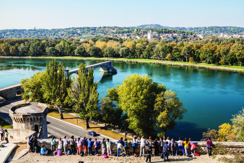 The Palais des Papes, a complex once designed to house rival popes, and a school group visiting the famous unfinished bridge in Avignon, another access city to the region.