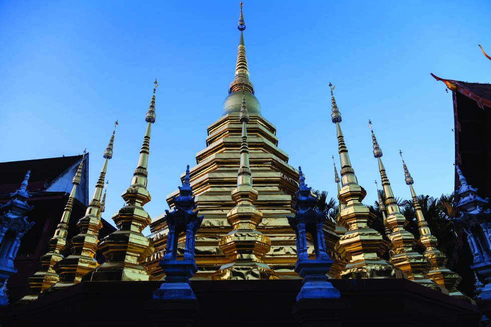 The northern style architecture of Viharn Lai Kam at Wat Phra Singh, dating from 1345. Below, the chedi at Wat Phan Tao at nightfall. The viharn, not shown, is constructed of teak.