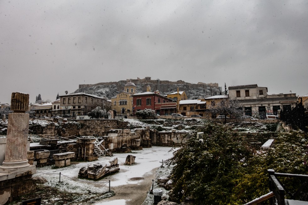 Looking up at the Acropolis in snowfall.