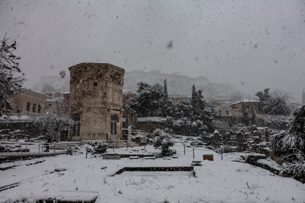 Looking up at the Acropolis in snowfall.