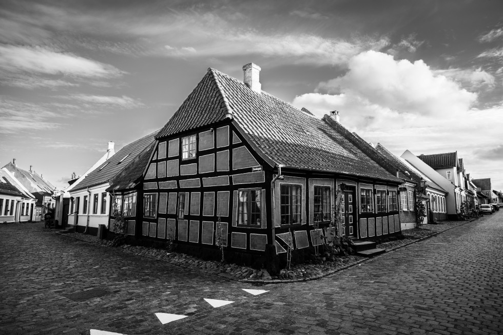 Corner houses on cobblestone streets.