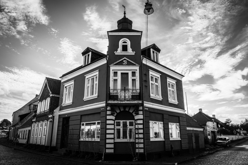 Corner houses on cobblestone streets.