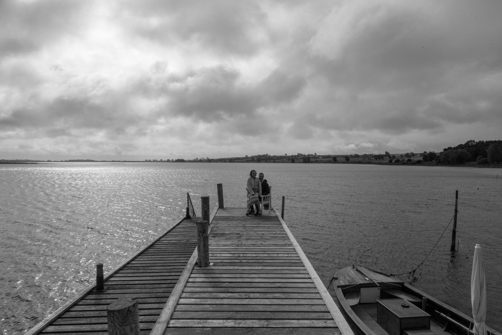 A newly married international couple take in the coastal landscape.