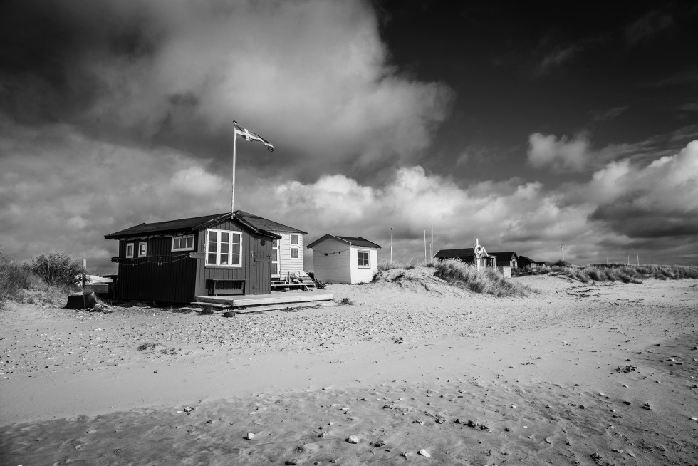 It is popular to own a beach hut for summer use; these sit on a narrow isthmus with ocean and beach along both sides.