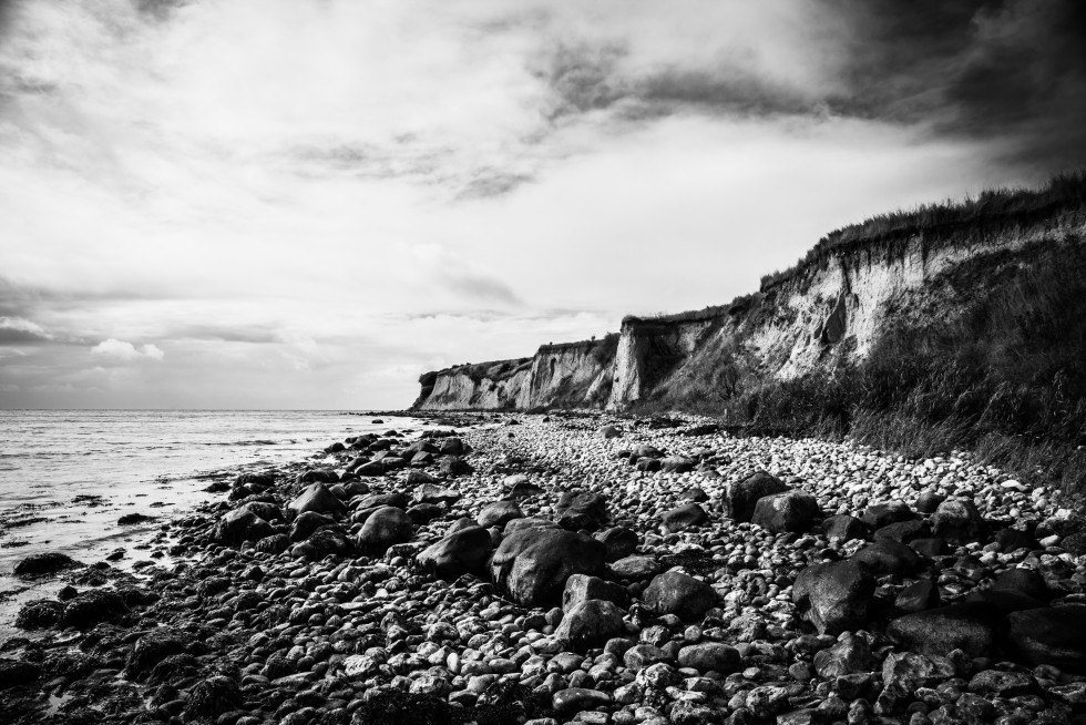 Austere cliffs and more colourful beach huts.