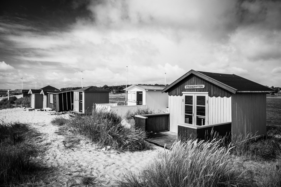 Austere cliffs and more colourful beach huts.