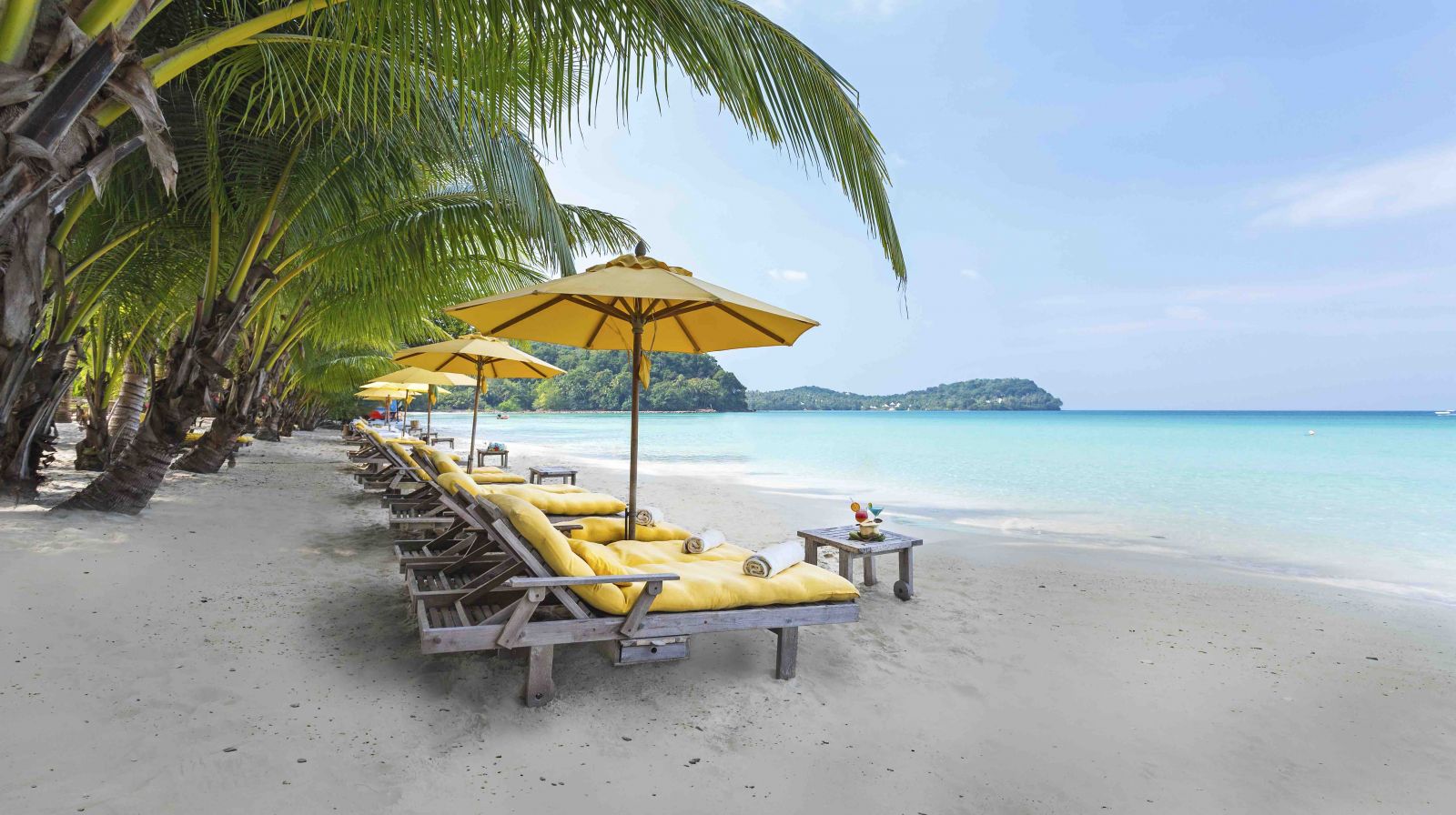 An exclusive private island getaway with swaying palms, white sands and clear waters.